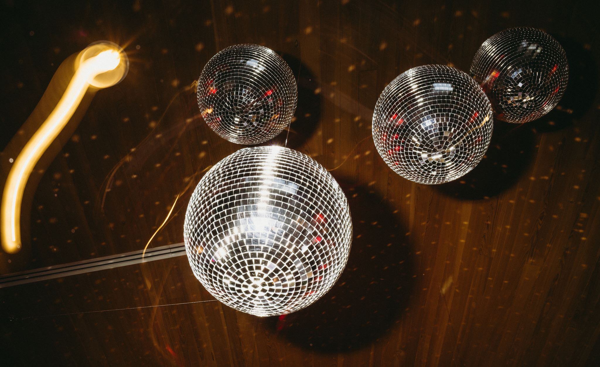 Disco balls hanging from the ceiling at a reception at The Grand Lady in Austin Texas