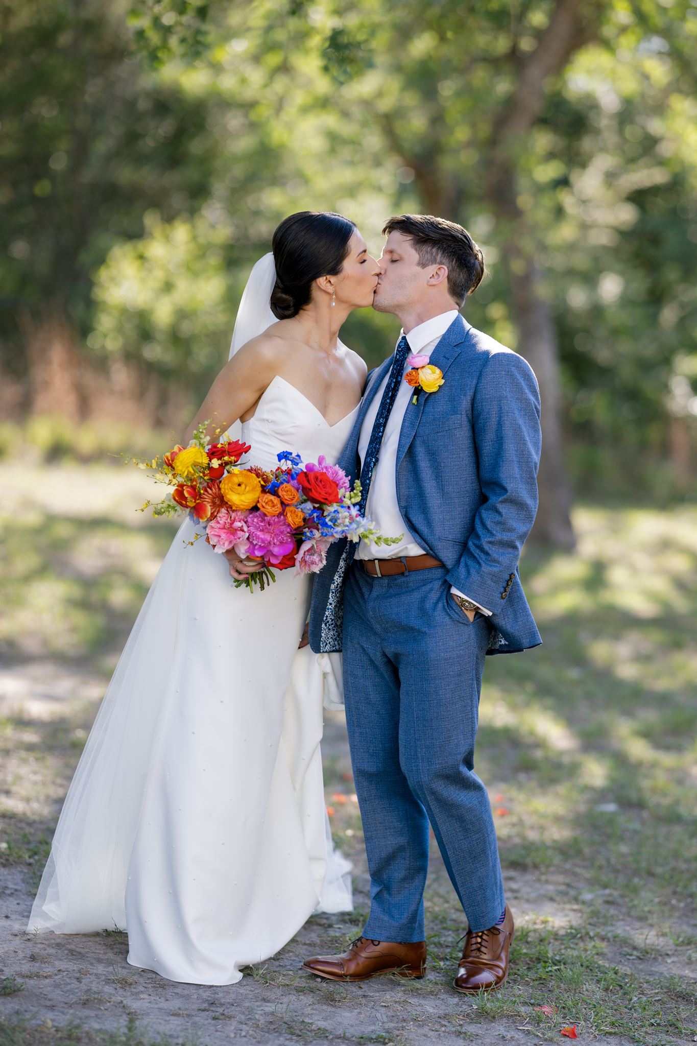 Bride and groom kiss during wedding portraits at The Grand Lady wedding venue in Austin