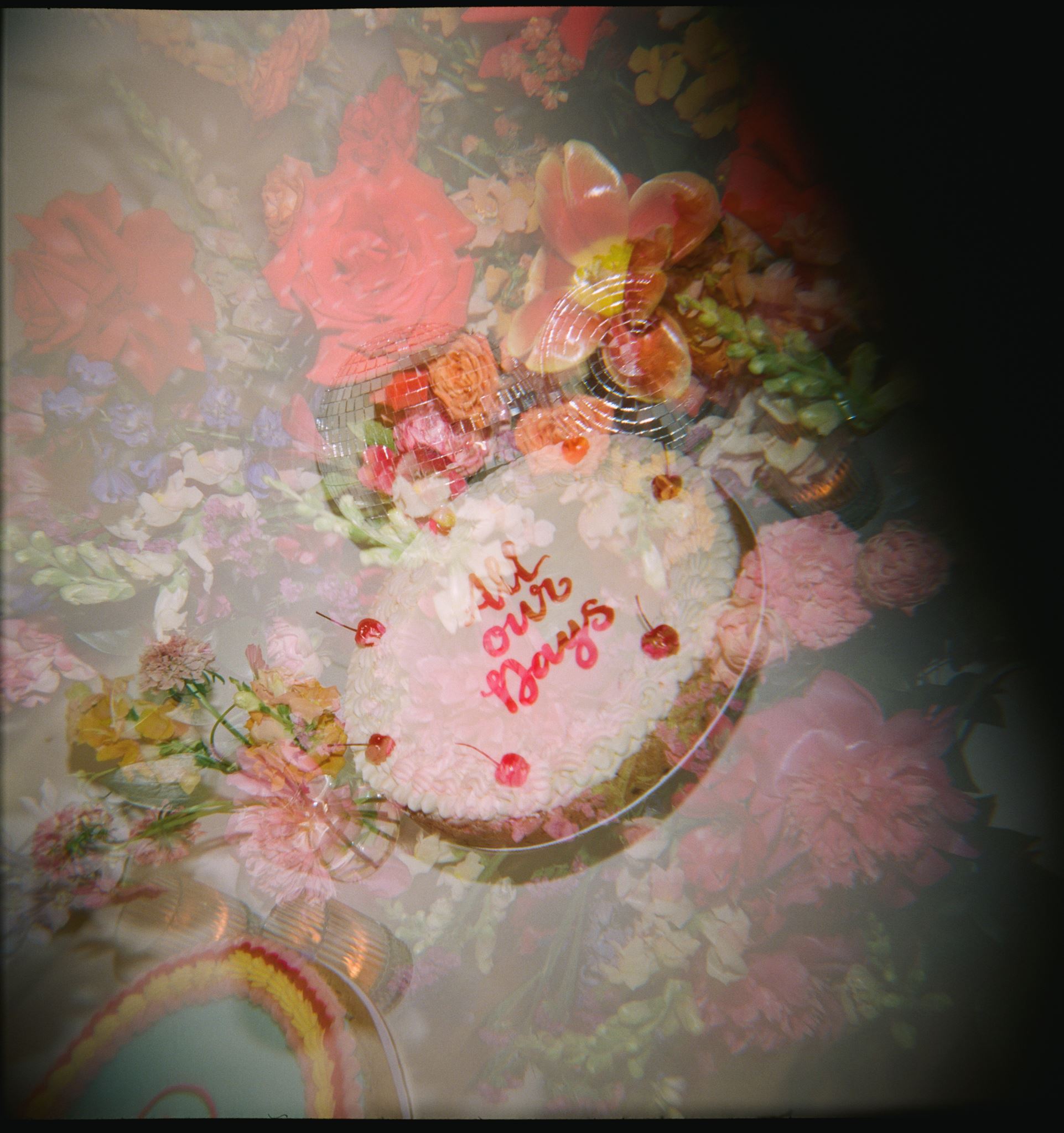Film photo of double exposure with colorful wedding flowers and a silver disco ball over wedding cake at the reception at The Grand Lady Austin wedding venue.